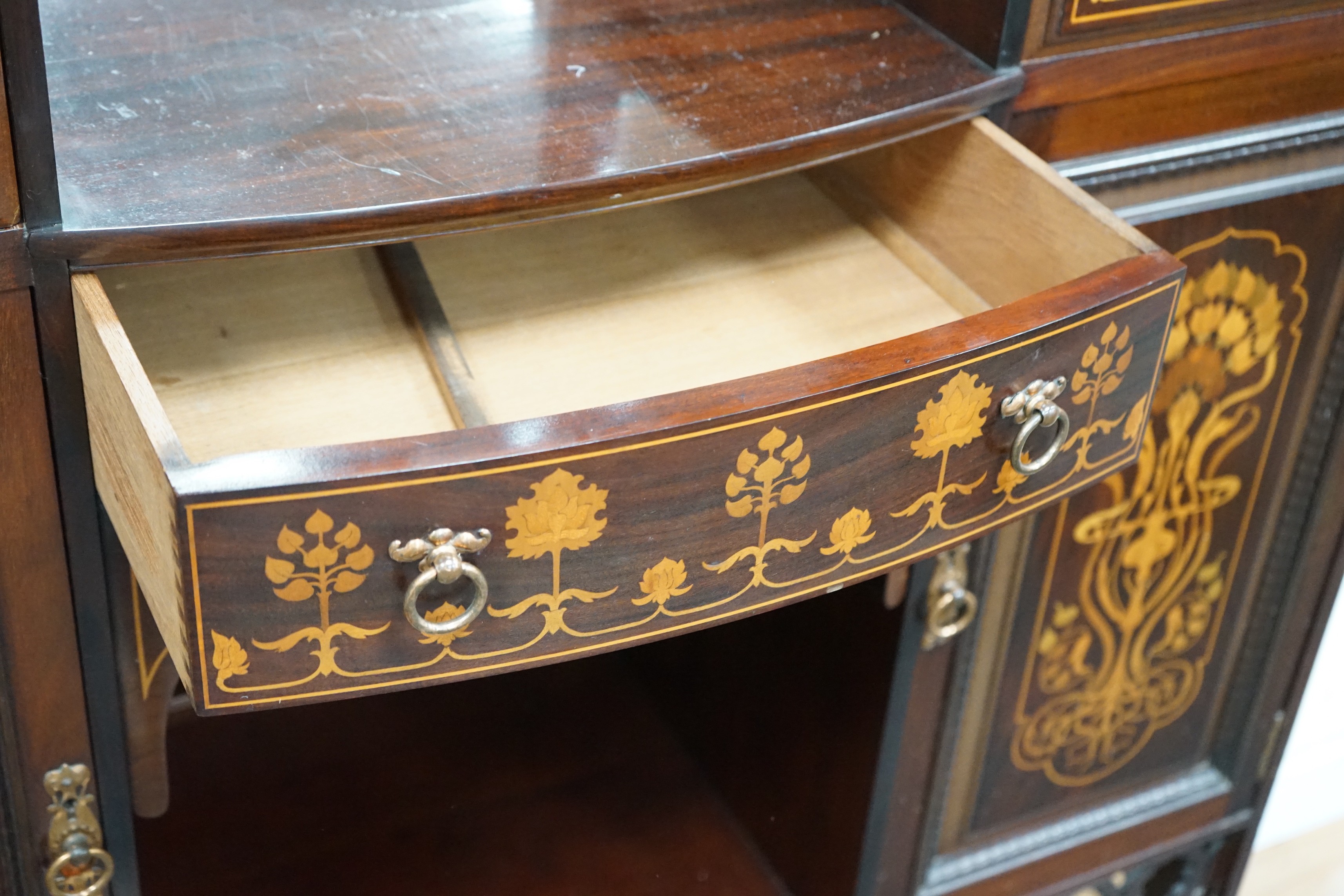 An Arts & Crafts marquetry inlaid mahogany amaryllis pattern side cabinet, in the manner of Shapland & Petter